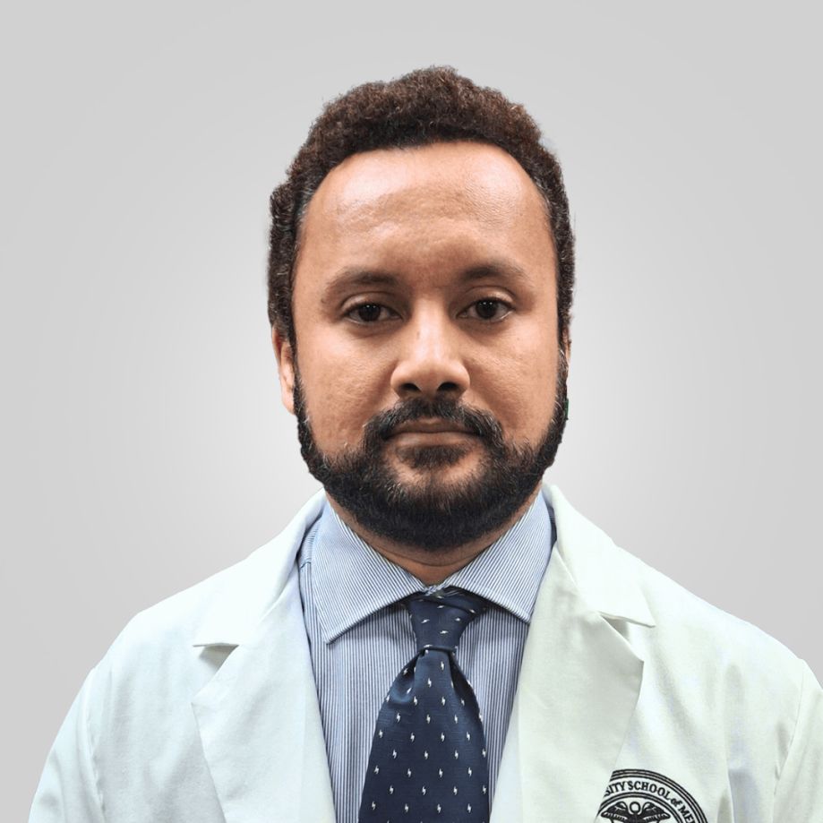 Faculty member in white coat and blue tie