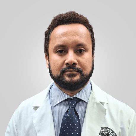 Faculty member in white coat and blue tie