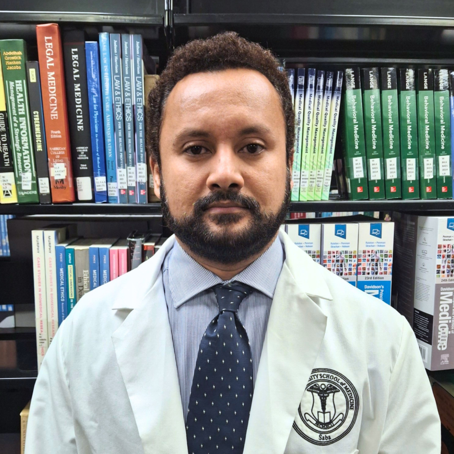 Faculty member in white coat and blue tie