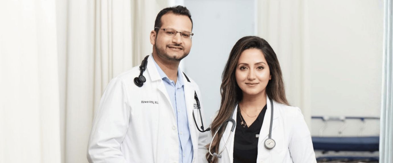 Male and female physicians with stethoscopes
